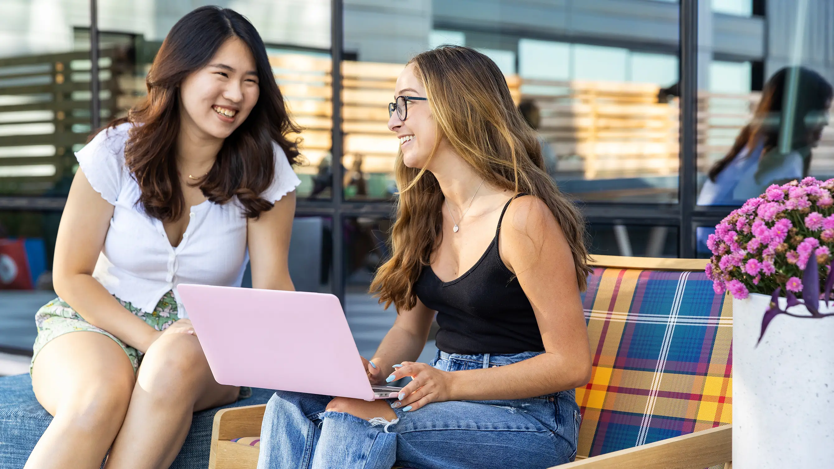 two women looking at a laptop