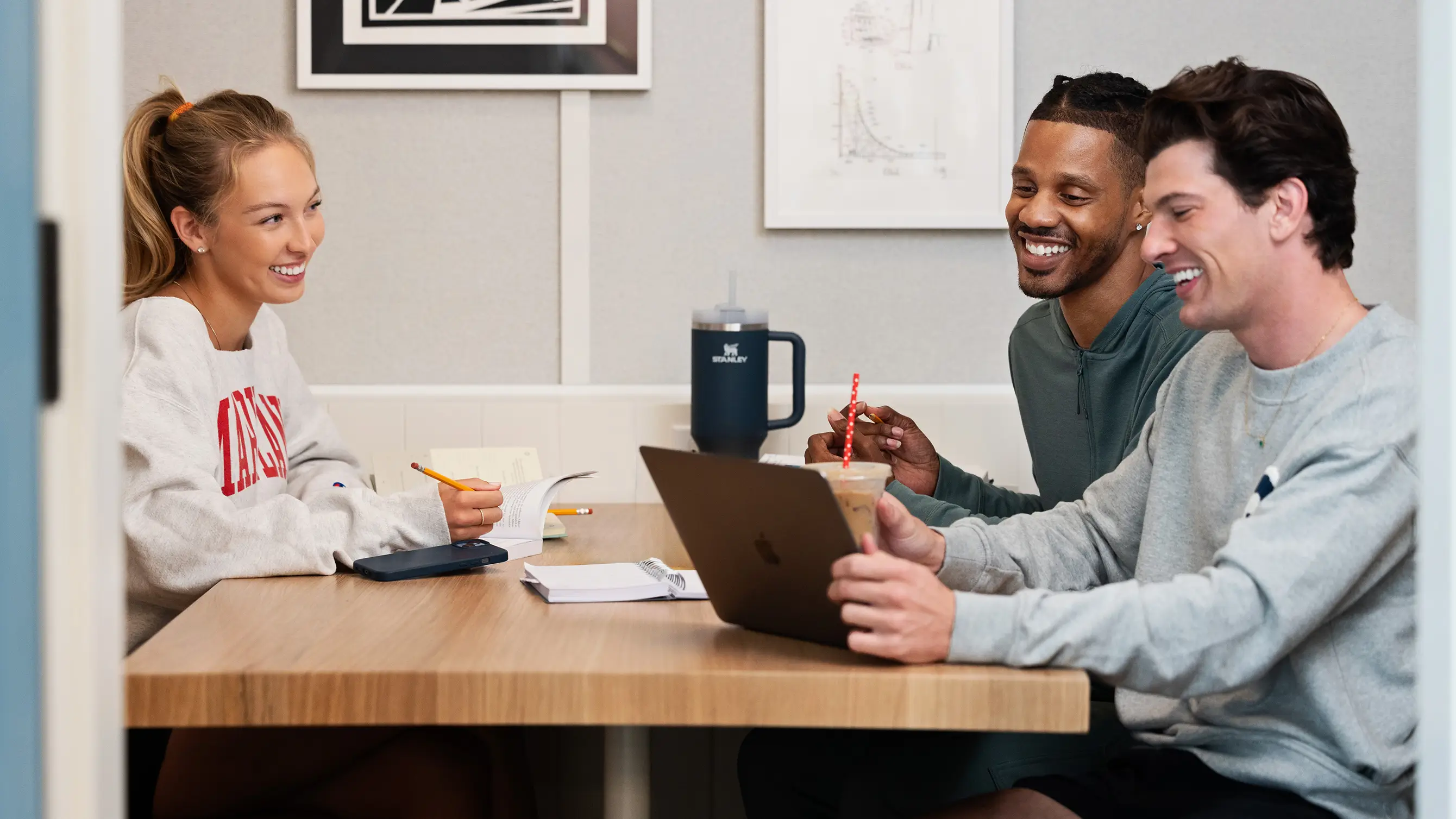 a group of friends looking at a laptop