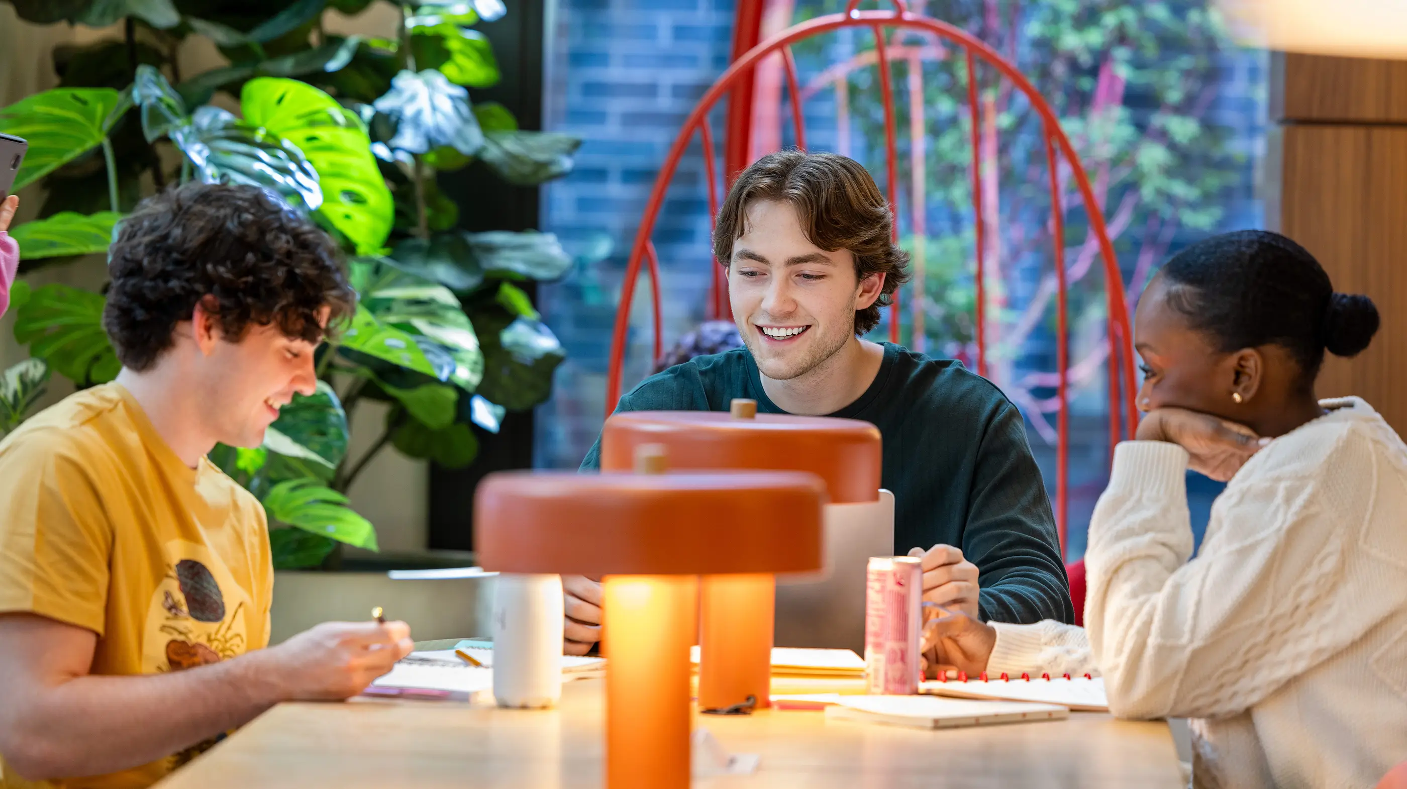 a group of friends writing in notebooks